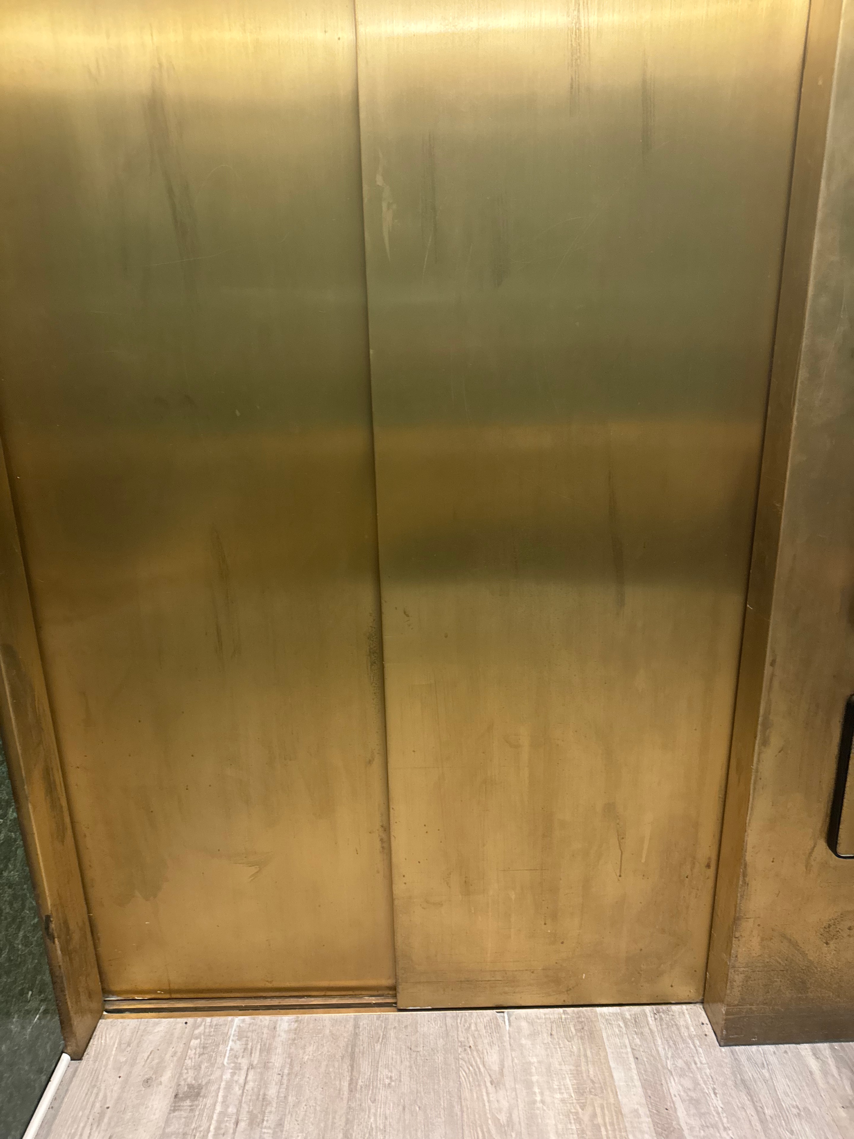 Brass elevator cab interior panels — oxidation and scratches