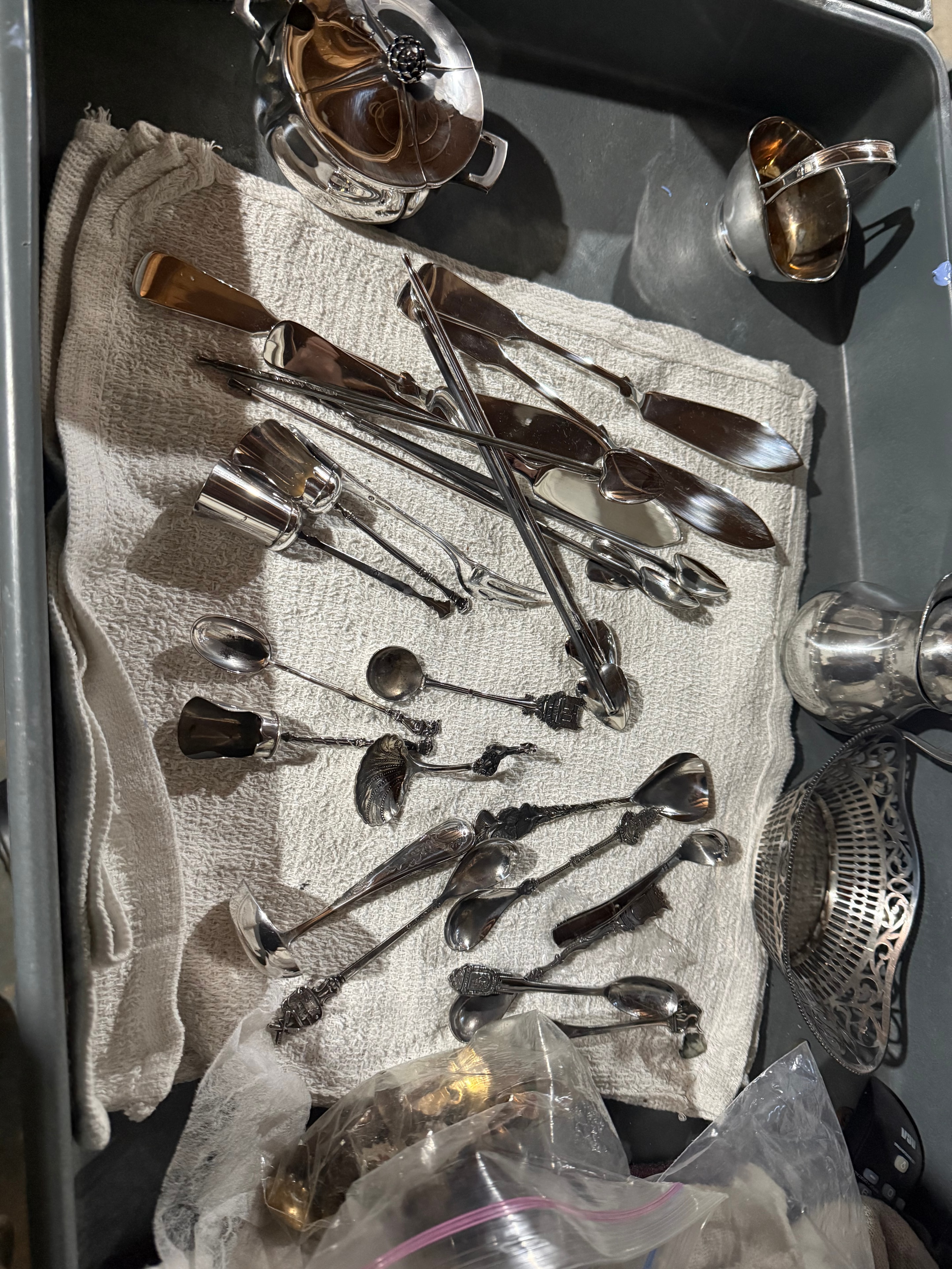 Polished silverware and serving utensils in a tray