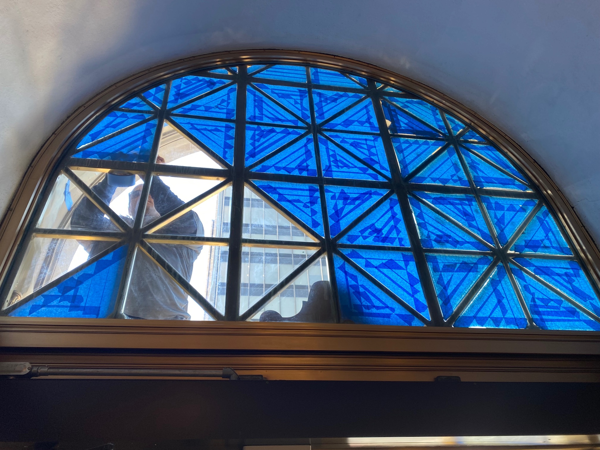 Brass fanlight window frame — during restoration